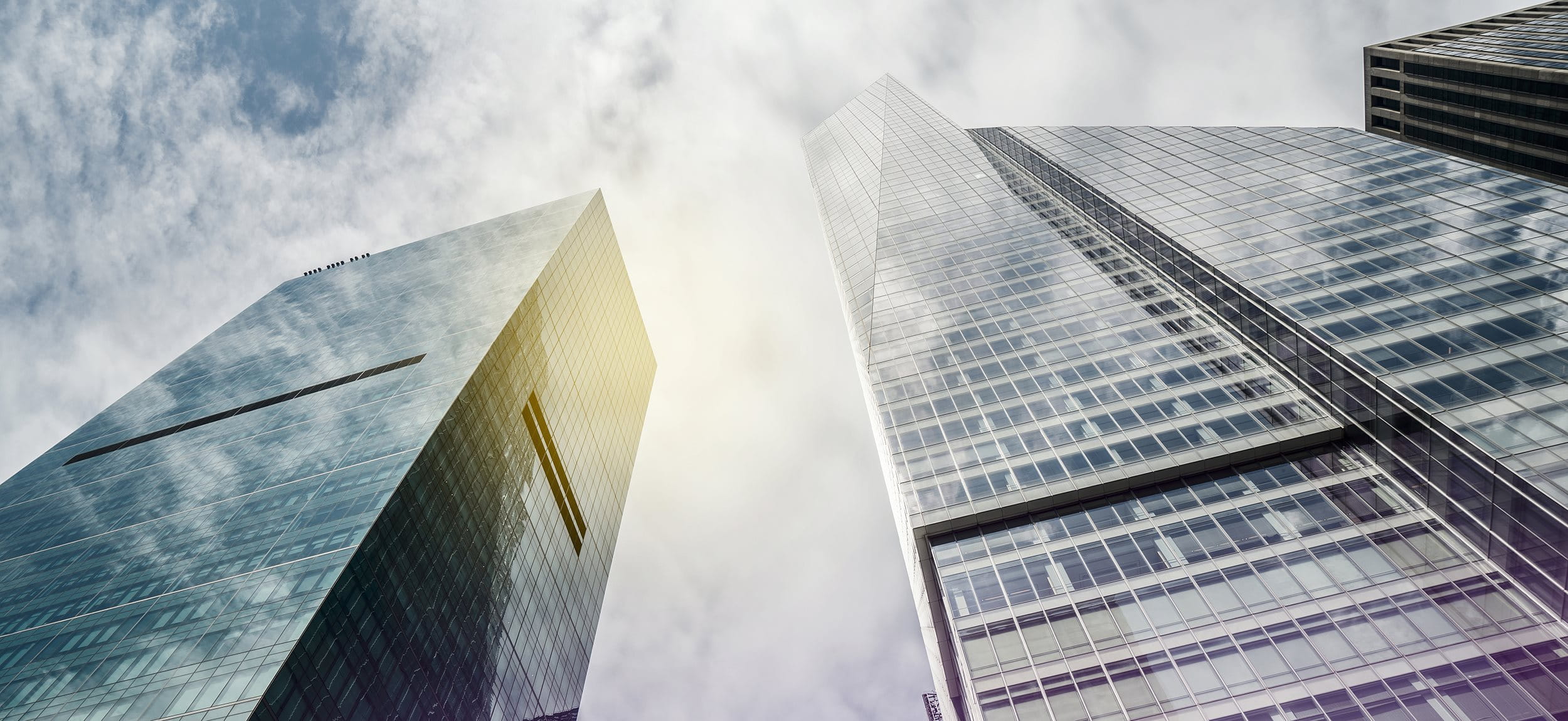 Several skyscrapers with sky and sun